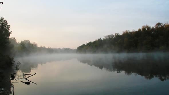 Smoke on the water. A beautiful lake on the background of the green forest