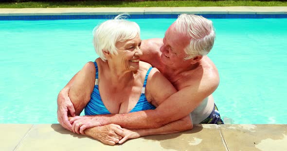 Portrait of senior couple embracing each other in pool