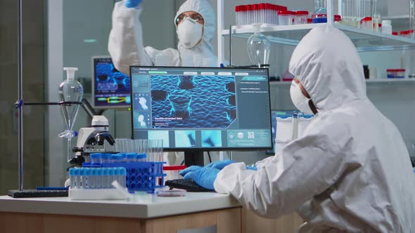 Medical Scientist in Ppe Suit Working with DNA Scan Image