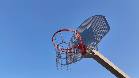 Slow motion shot orbit around basketball hoop