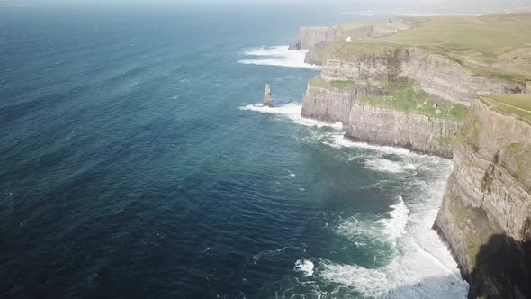 Drone scenic view of Cliffs of Moher during a sunrise next to the atlantic ocean, Ireland