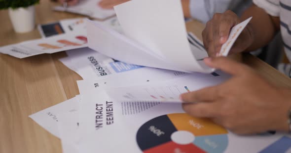 Close up docment of Asian young business people meeting in home office