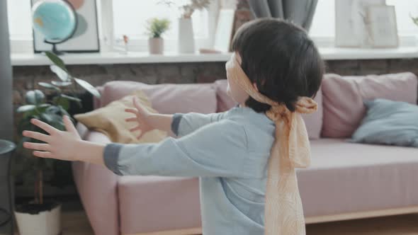 Boy Playing Tag with Friends at Home