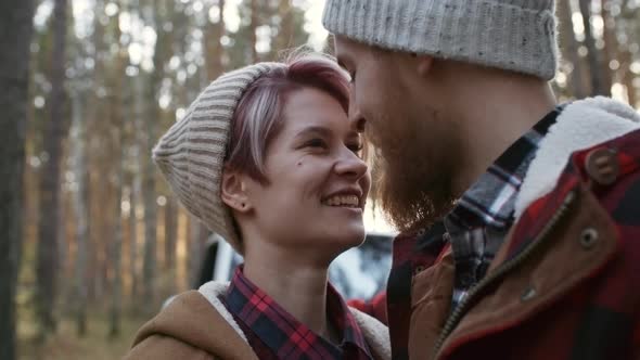 Faces of Loving Couple Kissing in Forest