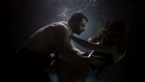 Breakup of Loving Couple Underwater Floating in Depth Man and Woman are Embracing