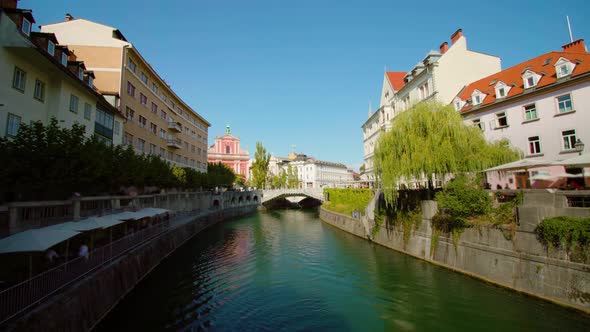 Long Water Canal with Plants and Houses Located on Banks