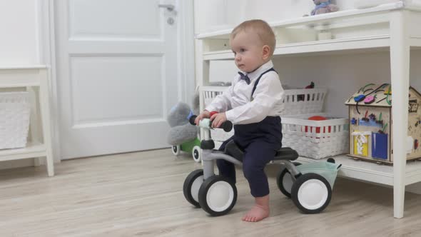 Kid on Baby Bicycle Balance Bike for Toddlers with Colorful Balloons 1 Year Old Baby Boy Celebrating