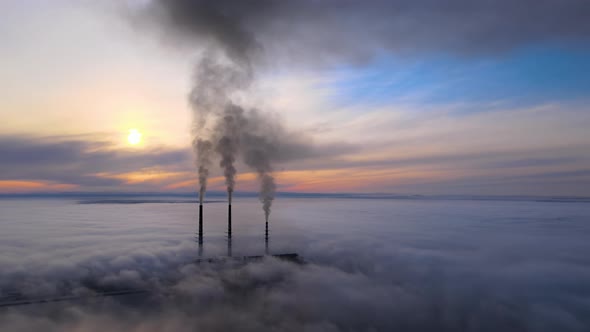 Coal Power Plant High Pipes with Black Smoke Moving Upwards Polluting Atmosphere