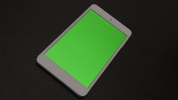 Modern design tablet computer on table green screen panning 4K 2160p 30fps UltraHD footage - Close-u