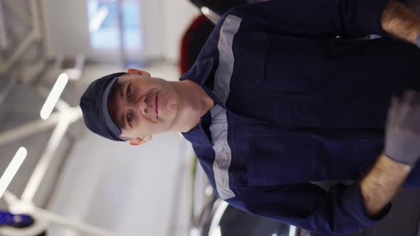 Portrait of a Smiling Mechanic Repairing in Uniform Standing Looking Camera Close Up