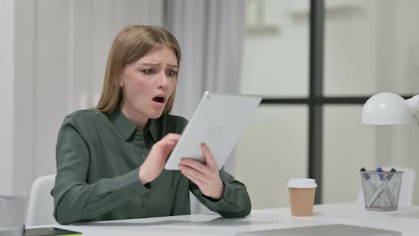 Disappointed Woman Reacting To Loss on Tablet 