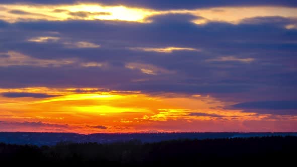 Dramatic Sunset in the Sky Through Orange Layered Cumulus Clouds Timelapse