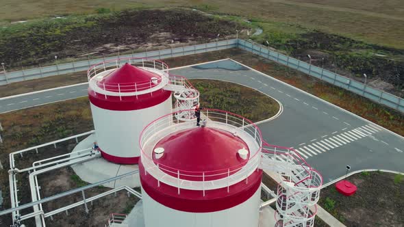 The Drone Takes Off Over Fire Tanks with Water at an Enterprise with an Opanny Production