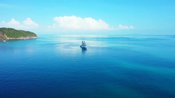 Aerial drone sky of tranquil shore beach break by transparent sea with white sandy background of a d