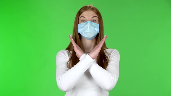Portrait of Young Girl in Medical Protective Face Mask Looking at Camera and Strictly Gesticulates