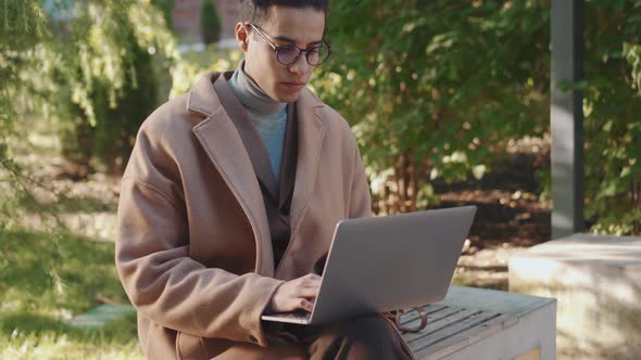 Concentrated Arabian man working with laptop