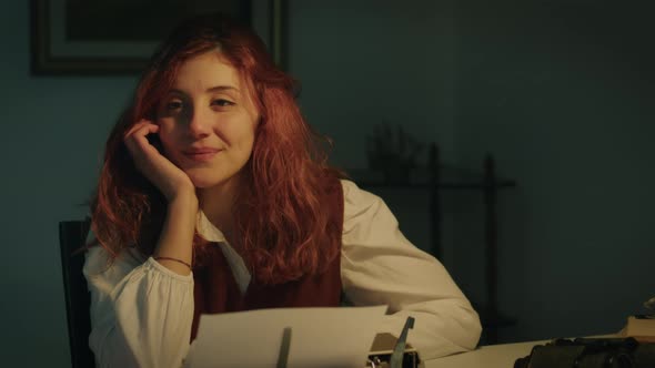 Girl Thinks About Who to Happily Write Her Letter on the Typewriter