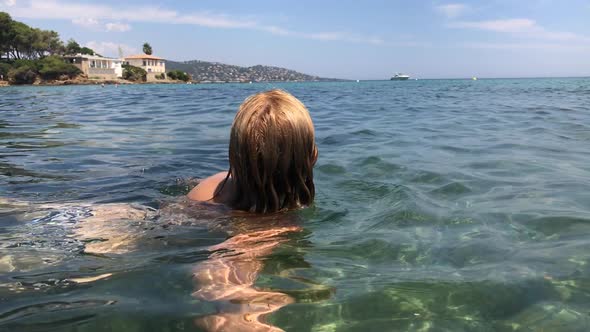 Caucasian woman enjoys swimming in crystal clear sea slow-mo  1920X1080 HD footage - Slow motion swi