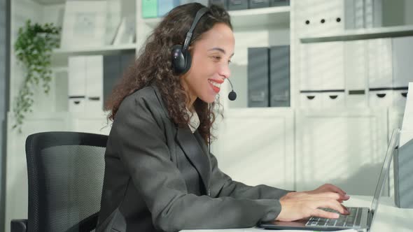 Beautiful Latino business woman call center dance while work in office.