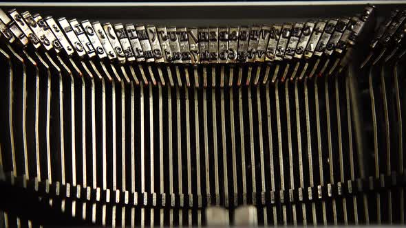 Mechanism of a retro typewriter. Old typewriter hammers. Close up.