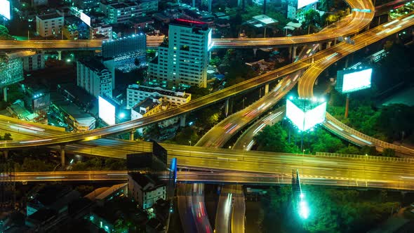 a top view of the city's car interchange at night. the movement of cars on the roads, light lines fr