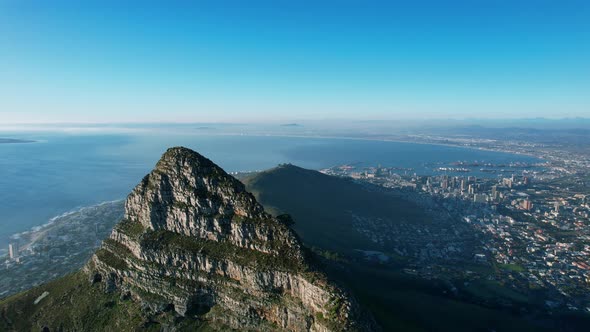 Lions Head mountain peak at sunset with view of Cape Town city bowl in South Africa, aerial
