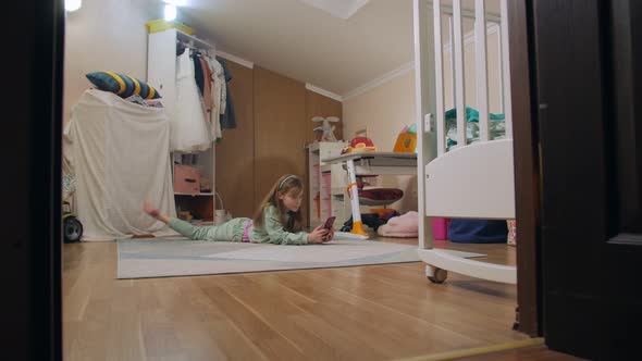 Girl Lying On The Floor With Smartphone