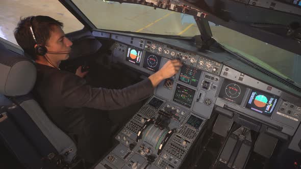 The cockpit of the aircraft. The pilot checks the plane before takeoff.