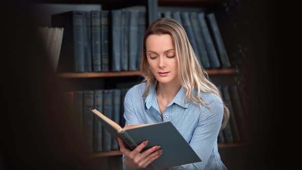 Clever Academic Woman Reading Interesting Vintage Book Turning Paper Page Enjoy Hobby at Library