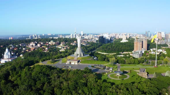 Aerial View of the Ukrainian Flag Waving in the Wind Against the City of Kyiv