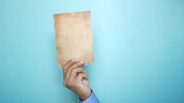 Holding a Blank Paper Against Color Background