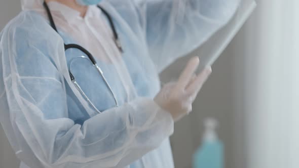 Camera Follows Transparent Face Shield As Doctor Putting on Protection