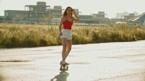 Young Attractive Woman Riding Skateboard Outdoors