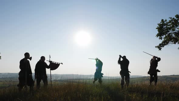 Silhouette of a Vikings practicing using the sword for battle.