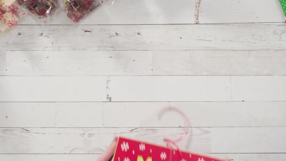 Flat lay. Step by step. Packaging homemade fudge and cookies into a Christmas gift box.