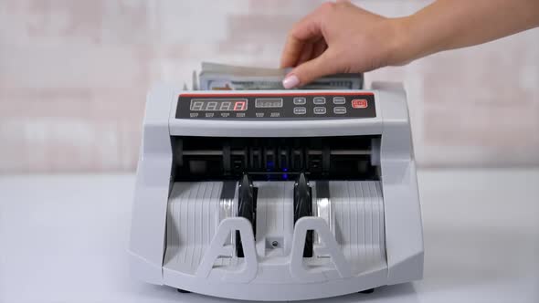 Money counting machine. Counting dollar banknotes.