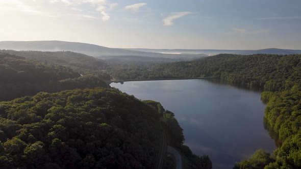 Aerial view over forest lake in the summer