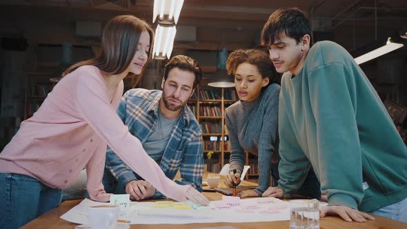 Motivated Multiethnic Business Group Gather Around Workplace to Develop Strategy