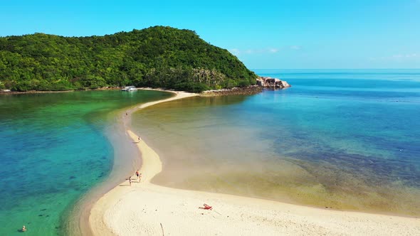 Aerial drone view seascape of tropical tourist beach break by aqua blue lagoon and white sand backgr