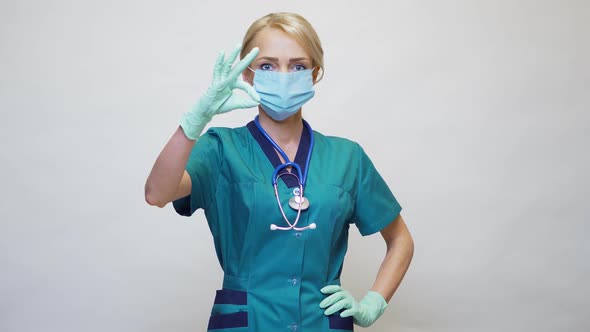 Medical Doctor Nurse Woman Wearing Protective Mask and Latex Gloves - Showing OK Sign