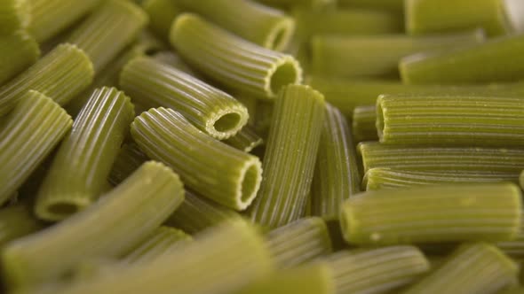 Green raw spinach vegetable vegetarian pasta. Falling in slow motion