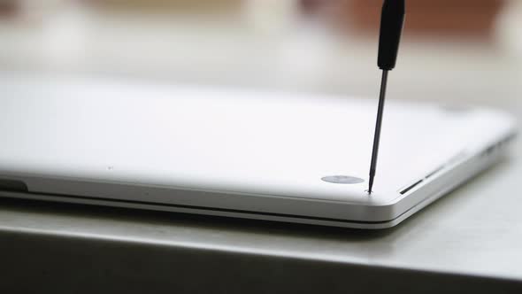 A Man Is Repairing a Laptop. The Concept of Computer Repair. Close Up of Man Repair Laptop