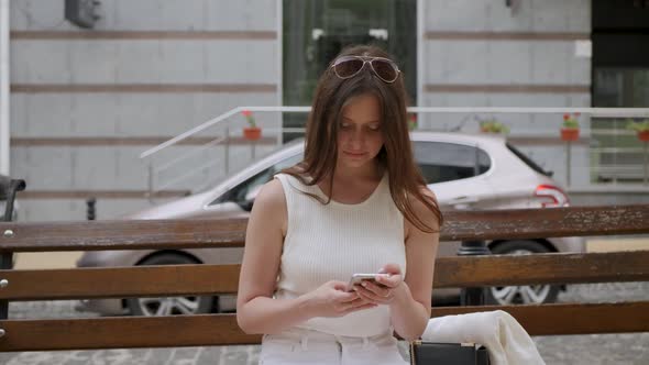 Young Woman Uses Smartphone