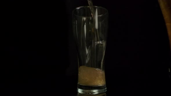 Beer Slowly Pouring Into Glass Cup