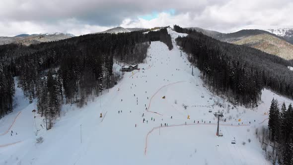 Aerial View on Ski Slopes with Skiers and Ski Lifts on Ski Resort in Winter