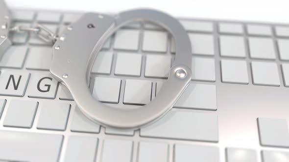 Handcuffs on Keyboard with HACKING Text on Keys