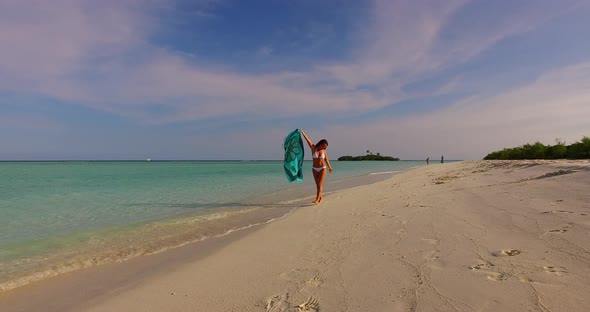 Modern happy lady relaxing spending quality time at the beach on sunny blue and white sand backgroun