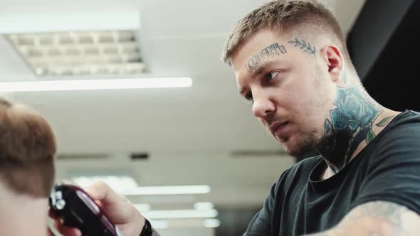 Hairdresser Makes Haircut To the Client