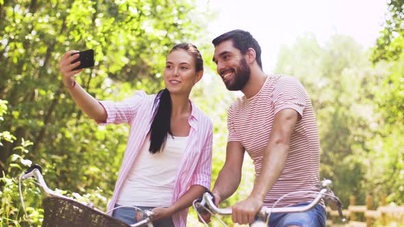 Couple with Bicycles Taking Selfie By Smartphone