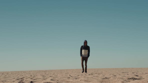 Man Walking Alone in the Sunny Desert Near Dubai Backpack Tourist Alone